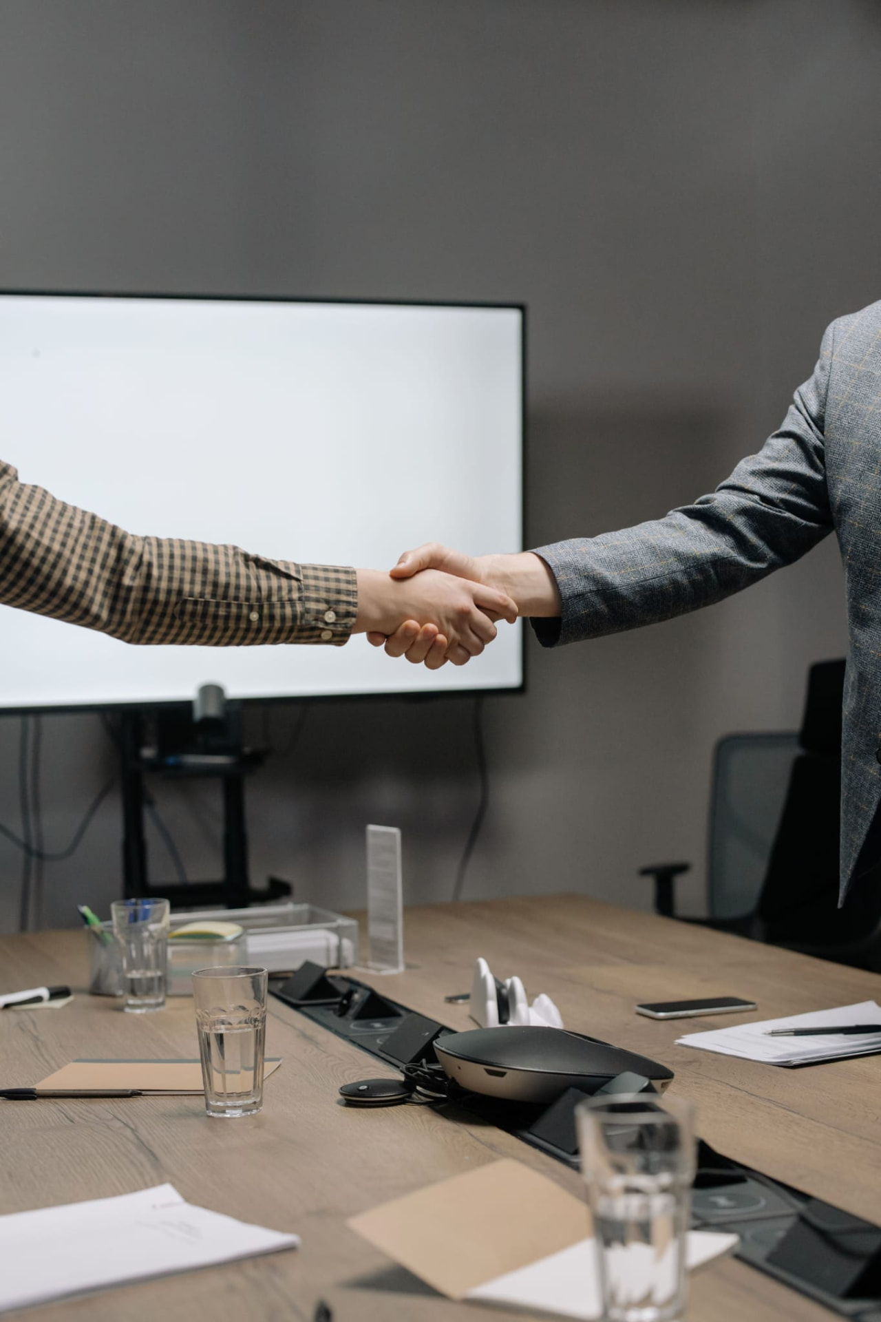 Two people shaking hands after a private briefing